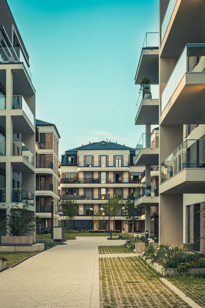 services-01 Contemporary cityscape featuring luxury apartments with balconies and outdoor pathways.