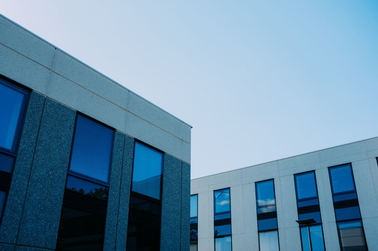 team-03 From below of contemporary office buildings with reflection in windows located in city